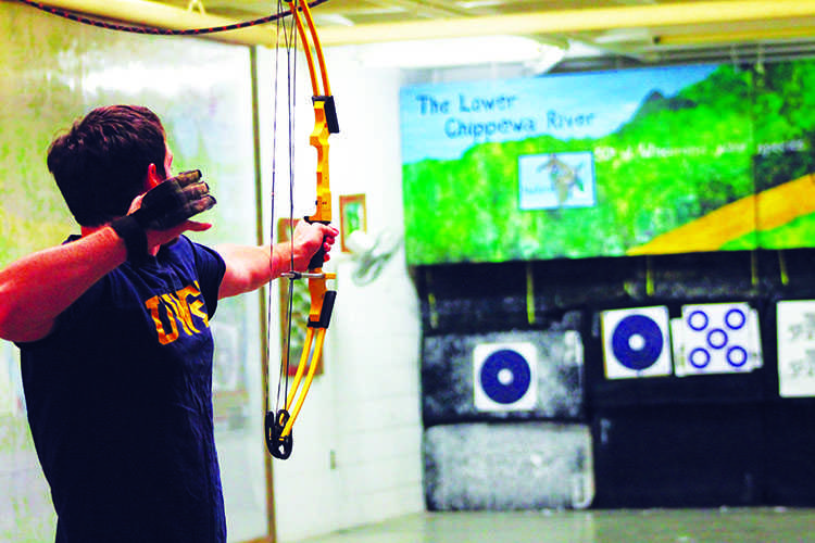 Junior Tim Bankes takes aim at targets Wednesday night at Hilltop Center.