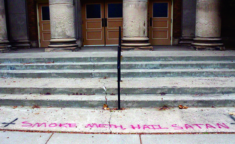 Satanic scribbling sullies church sidewalk 