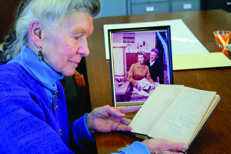 Joan Schmidt reads Robert Frost work that she donated to UW-Eau Claire. The Robert Frost collection at McIntyre Library is open to UW-eau Claire staff, faculty, students and the community. © 2014 Emily Albrent. 