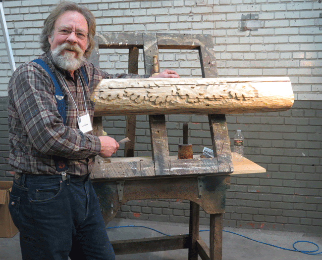 Kevin Midthun, a woodcarver out of Eau Claire, showing off a mantle that he is currently working on. © 2014 Katy Macek                           