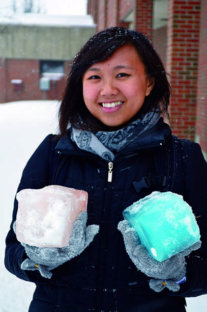 Senior Alaythea Herr holds two of the expected 400 ice blocks that will be needed to complete the ice sculture. © 2014 Danielle Pahl