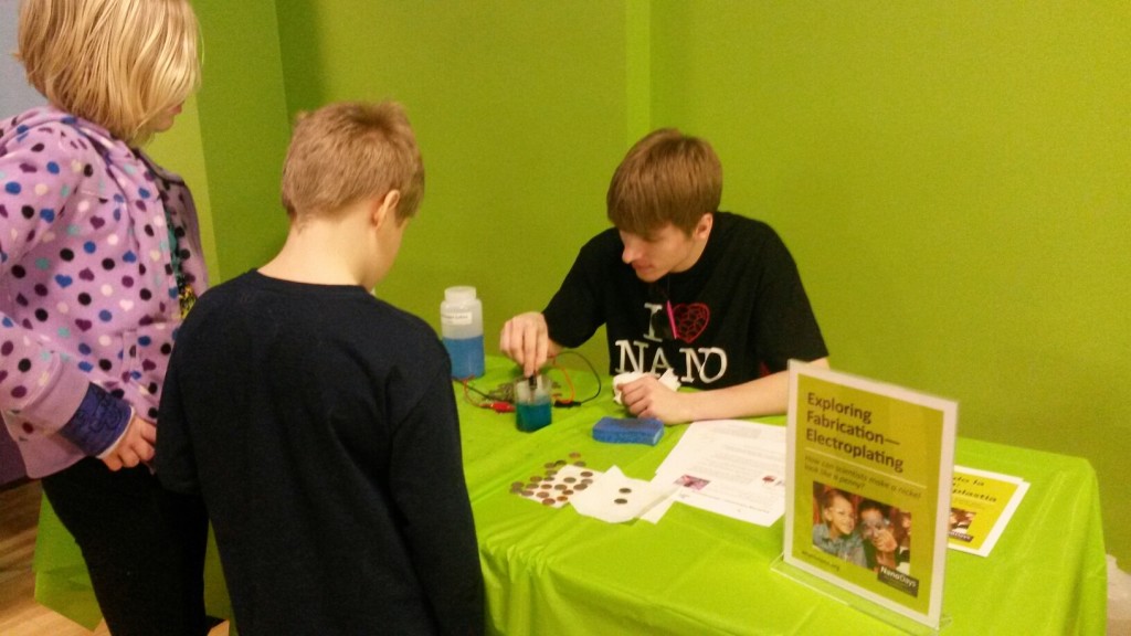 UW-Eau Claire senior Owen Szulgit demonstrates the separation of ions from one object to another as part of the NanoDays event, put on by the Material Science Center, Tuesday at the Children’s Museum of Eau Claire. © 2014 Steve Fruehauf