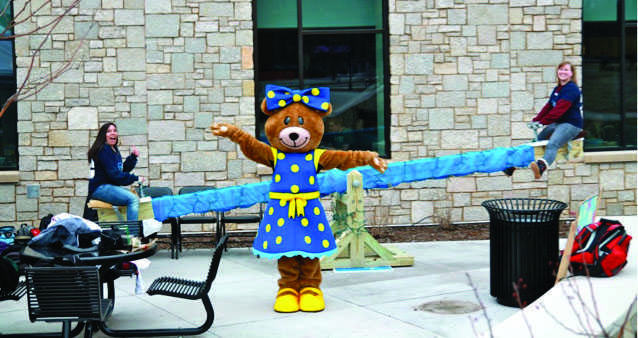 SEE THE SEE-SAW : Junior Andrea Clark-Johnson, BetXi Bear and alumna Anja Meerwald teeter-totter for autism awareness at last year’s event. This year’s Teeter-Totter-A-Thon will take place April 16. Submitted