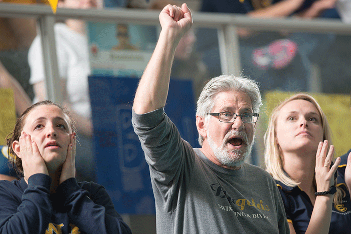 LAST HOORAH: UW-Eau Claire swimming and diving head coach Art Brandt, middle, celebrates one of the teams meets earlier this season. Submitted