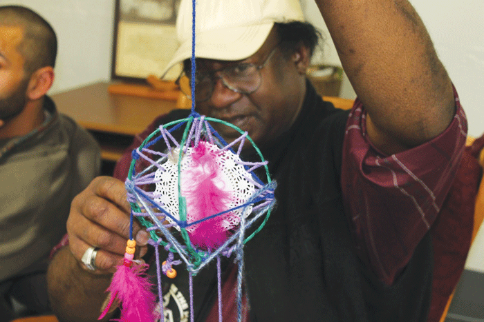 GETTING CRAFTY: Larry Coleman, with the intricate dream catcher he made at Positive Avenues on Friday, had been volunteering there for more than four years. © 2014 Jessie Tremmel, The Spectator