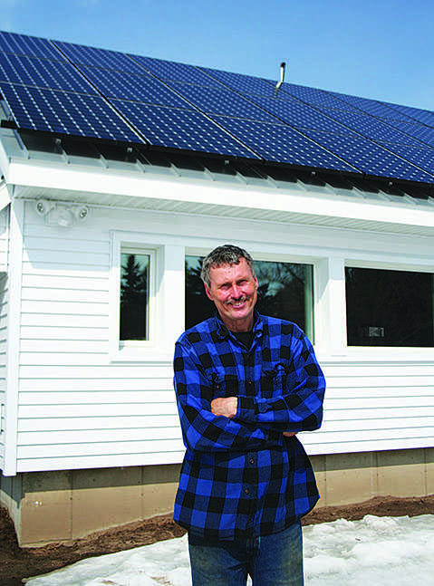 SUN SAVINGS: Jim Dickerson built this solar panel array last summer. Hes now running his house on clean energy alone. © 2014 Nate Beck