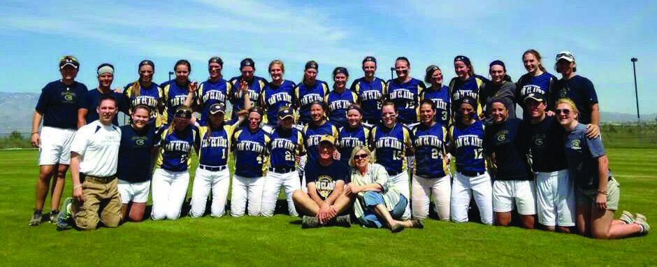TRUE BLUGOLDS: Tim and Sue Rogge, center, pose with the UW-Eau Claire softball team earlier this season. The Rogges have been avid followers of the Blugold womens basketball, volleyball and softball teams since 2002. Submitted