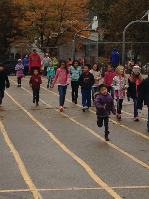 Students run and walk the lap’s final straightaway.
