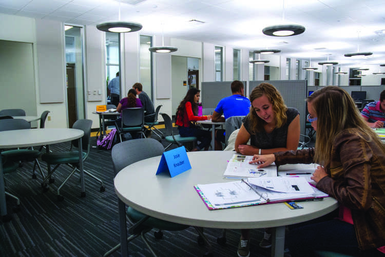 Tutor Josie Knauber helps Emily Long with her homework.