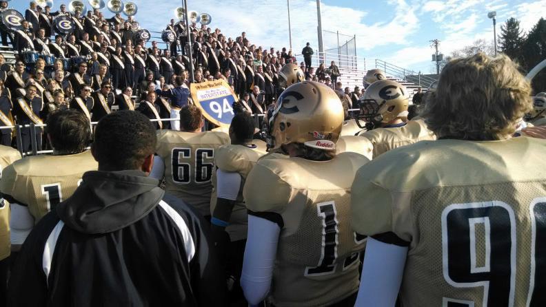 The UW-Eau Claire football hoists the War on 94 trophy after beating UW-Stout Saturday afternoon at Carson Park.