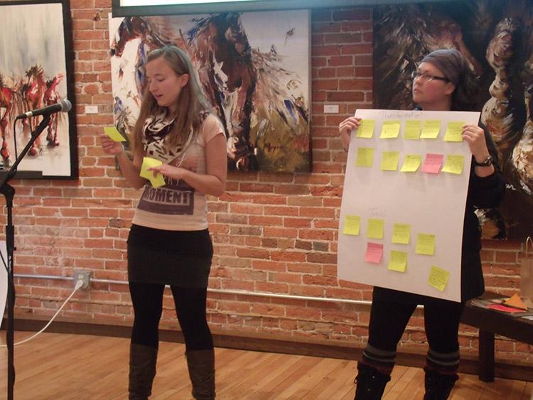 Jenny Rieger, left, presents for the audience at the Volume One Local Store Gallery. - Photo by Sam Martinez