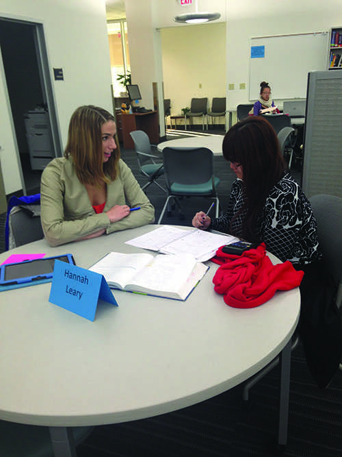 Senior Hannah Leary tutors sophomore Nancy Lor once a week in the Academic Skills Center in the subject actuarial science. The two have been meeting during the course of the semester.  - Photo by Meghan Hosely

