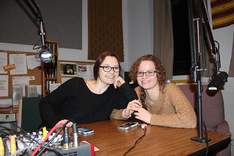 Sammy Gibbons and Emma Barnhardt joke with each other Tuesday night in the WHYS 96.3 FM Eau Claire Community Radio booth in downtown Eau Claire. The Memorial High School seniors host a weekly program, “Generation WHYS.” Barnhardt and Gibbons have both taken classes at UW-Eau Claire through the Youth Options program, along with being full-time high school students and partaking in extracurricular activities.