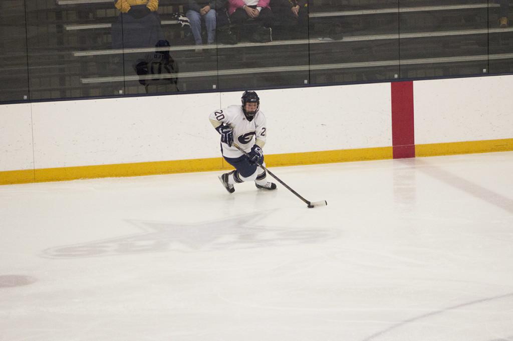 Senior Andi Husted skates up ice into the Yellow Jackets zone looking for a shot Friday night.