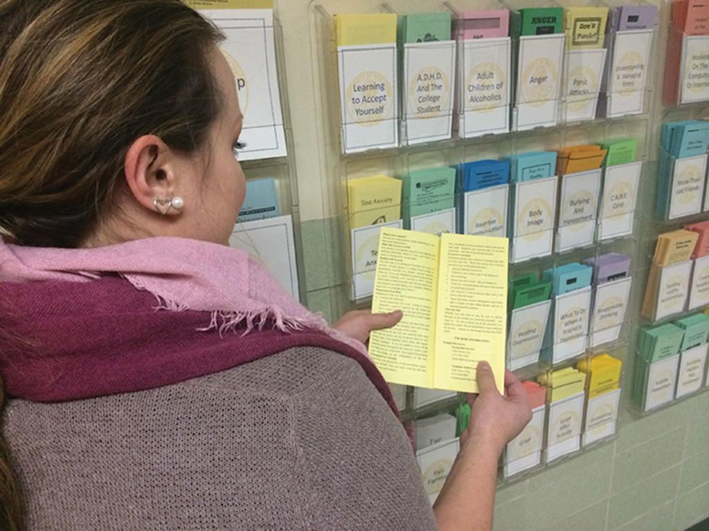 Ashley Galoff, the Master’s Level intern at Counseling Services at UW-Eau Claire, explains a pamphlet discussing the signs of test anxiety. Counseling for test anxiety is among the services provided by the free center located in Old Library, making it a viable option for low-income students.