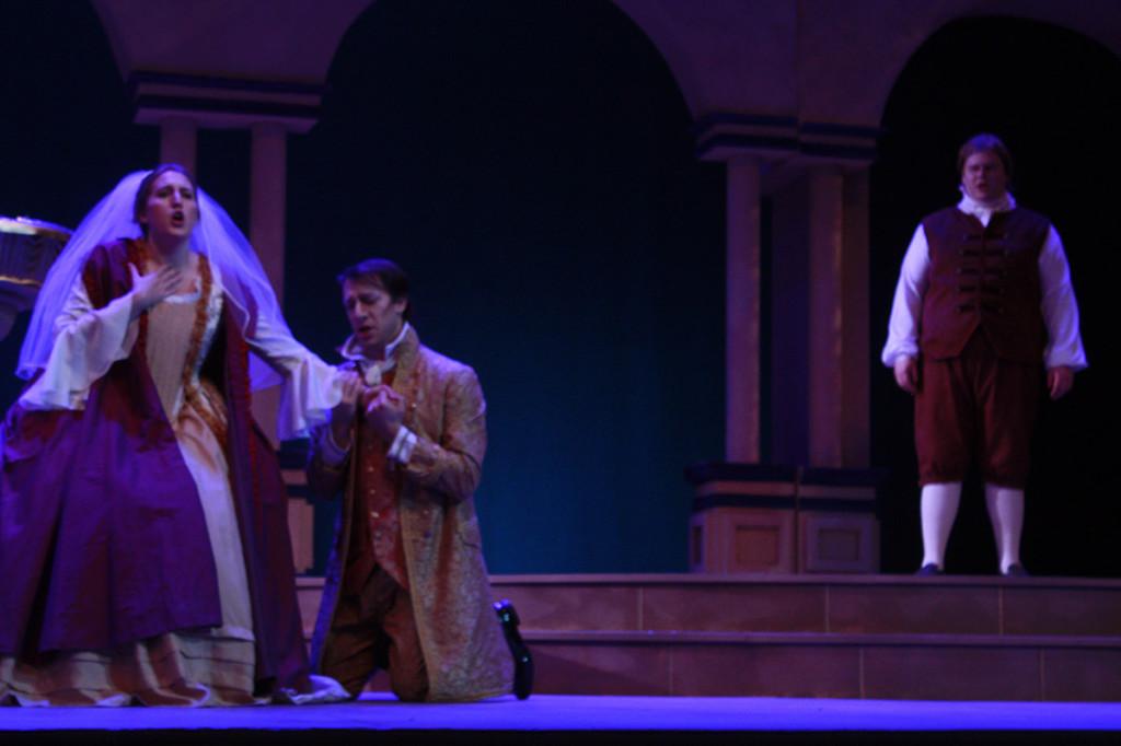 Seth Hale (middle) as Count Almaviva is trying to seduce Kelly Noltner (left) as Susanna while Jacob Burgess (right) as Figaro watches.