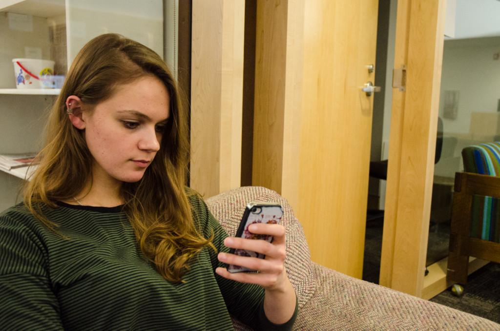Copy Editor Lauren French takes a moment to text a friend back in The Spectators office.