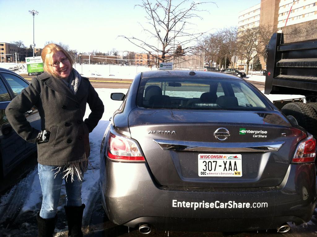 Junior Sarah McKlveen, history and math teaching dual major, checks out the two cars available for rent.  The Nissan Altimas are located on University Avenue on upper campus.