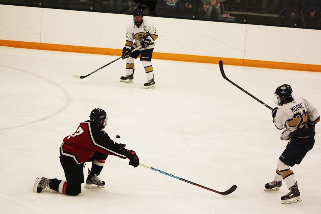 Patrick Moore passes the puck to Jack Callahan against the Falcons.