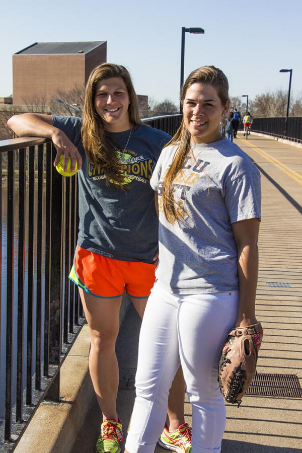 Senior softball captains Amanda Fischer and Nikki Brooks take to the footbridge before practice.