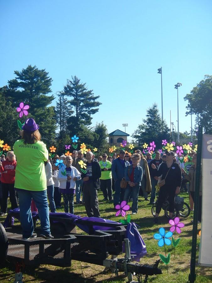 Walkers hold up their Promise Garden flowers to show their support.