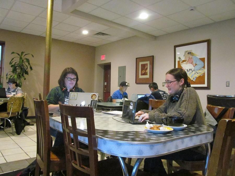 Aimee Johnson and Cheryl O’Brien write during National Novel Writing Month during a write-in at  Racy’s. 