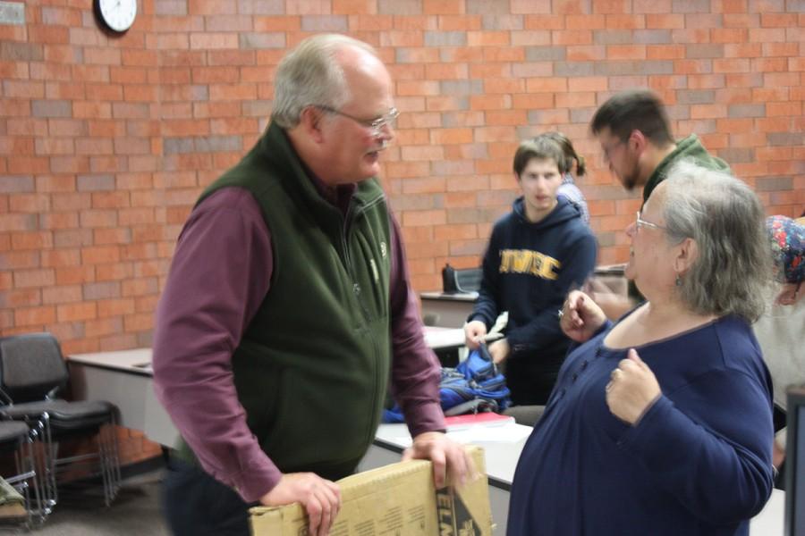 Former State SenatorDale Schultz, R-Richland Center, stays late after his presentation to speak with Margaret Cameron of Eau Claire about education.