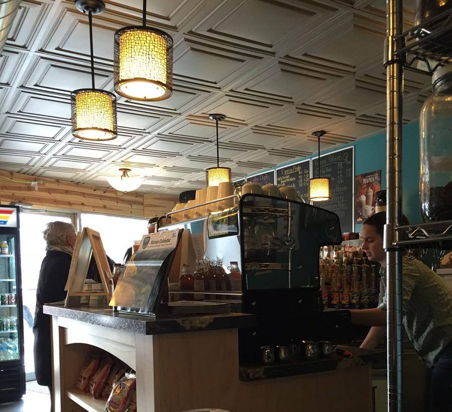 Students work as baristas behind the counter making an assortment of drinks and food at The Goat Coffee House located on 336 Water St.