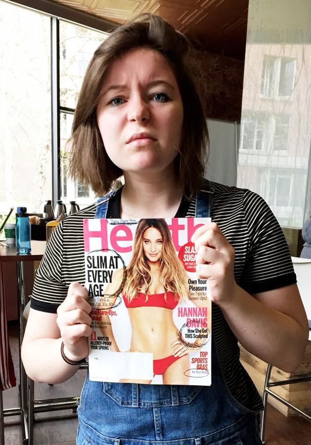 Eat To Shrink: Hultman disgustedly holds a copy of Health magazine, which promotes weight loss all over the cover and has numerous articles inside telling women to lose weight, despite their weight gain being attributed to natural, healthy reasons such as childbirth
