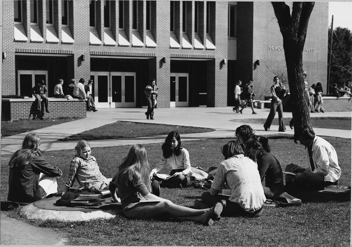 Students sitting in a circle, studying outside Schneider Social Science Hall, 1976; Object ID#: AS279.005.004.001