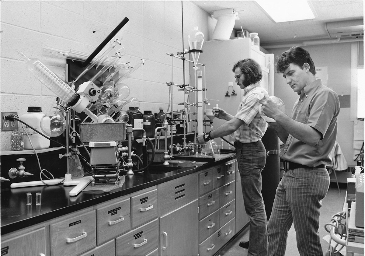 Two male students conducting a science experiment with beakers and test tubes, in L.E. Phillips Science hall, ca. 1970s; Object ID#: AS279.004.006.002