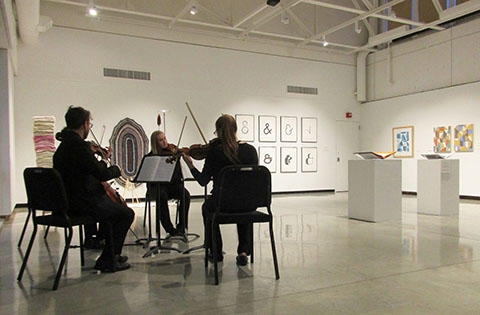 The Rococo String Quartet performed amidst alumni art in the Foster Gallery.