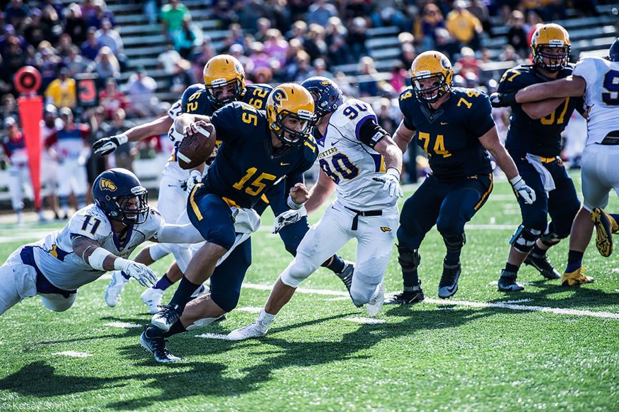 Quarterback JT Denhartog escapes the UW-Stevens Point defense, picking up yards for the Blugolds.