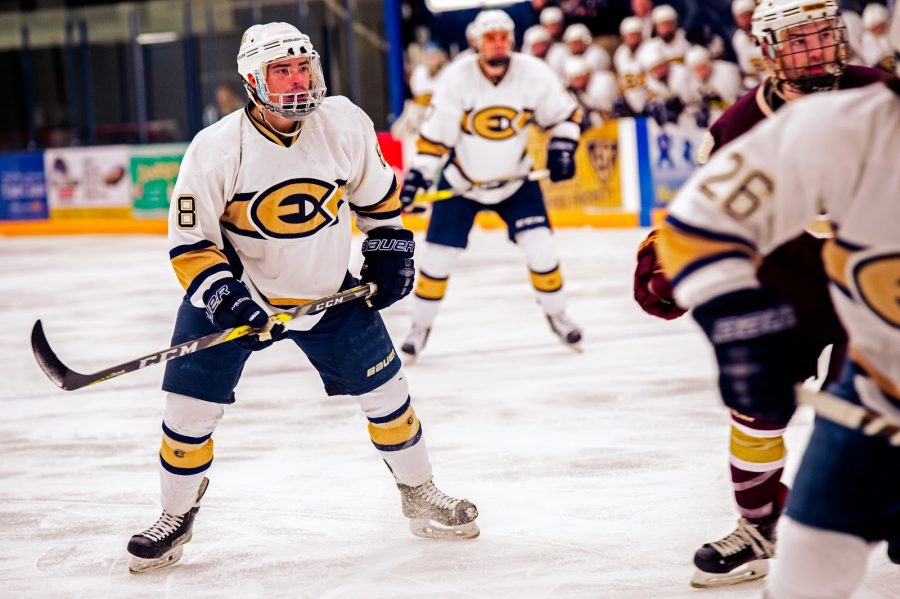 Junior Blugold hockey player, Colton Wolter, stands ready to assist his fellow teammates score a goal.