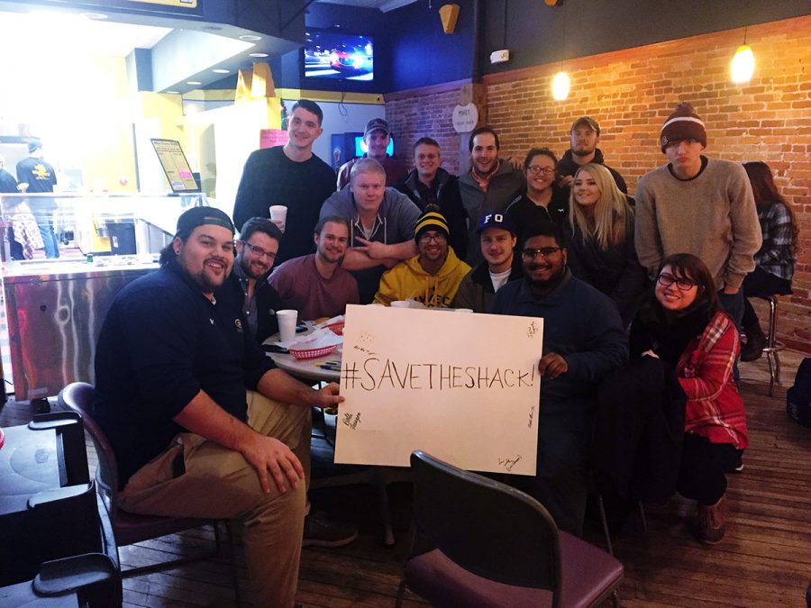 UW-Eau Claire students rallied around Mike’s Cheese Shack last Friday night, holding a sign that eventually received around 100 signatures. 