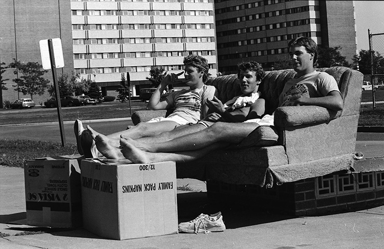 These UW-Eau Claire students are pictured in 1980, relaxing in between their move into the residence halls on upper campus.