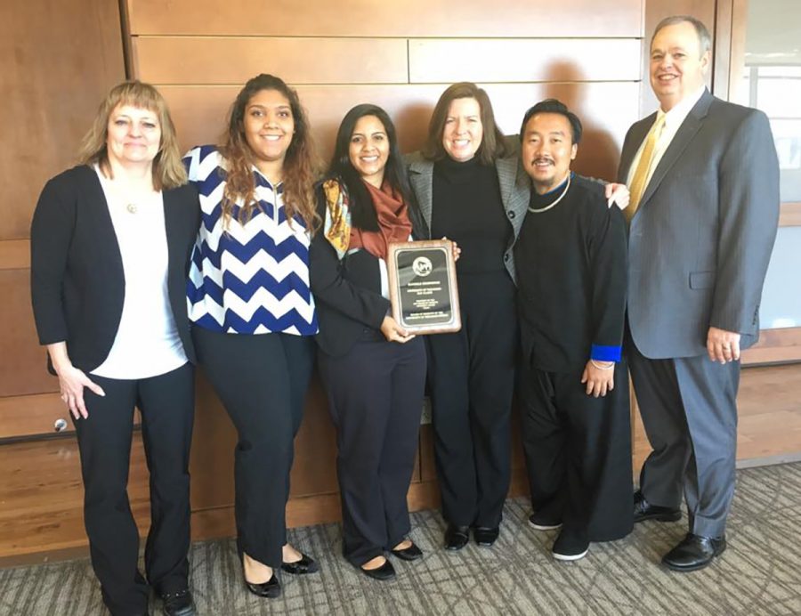Members of Blugold Beginnings accepted the $5,000 award Feb. 3 at the Board of Regents meeting in Madison. (Pictured left to right: Cheryl Snobl, Whisper Kappus-McDew, Karen Dominguez, Jodi Thesing-Ritter, Khong Meng Her and Chancellor Jim Schmidt. Not pictured: D’Karlos Craig, Dennis Beale, Crystal Vang and Olivia Vruwink).