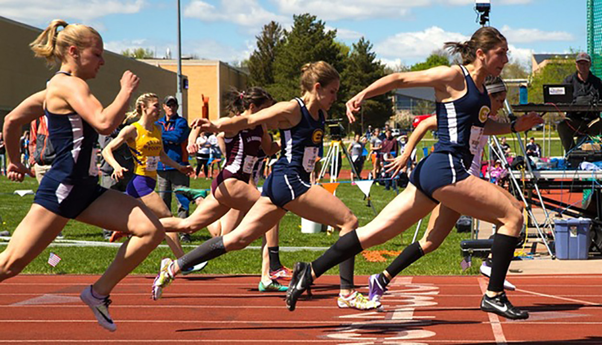 (From left) Ashleigh Buergi, Claire Fischer and Kelsey Worachek cross the finish line in the 100-meter dash. 