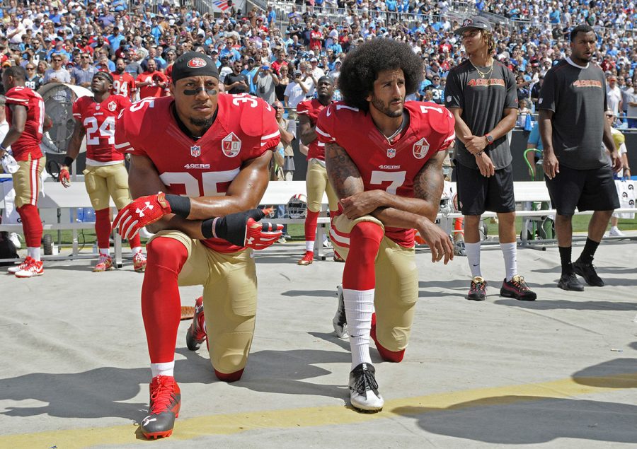 Colin+Kaepernick+%28right%29+kneels+during+the+national+anthem+next+to+former+teammate+Eric+Reid.+Previously+members+of+the+San+Francisco+49ers%2C+both+men+are+currently+free+agents.+