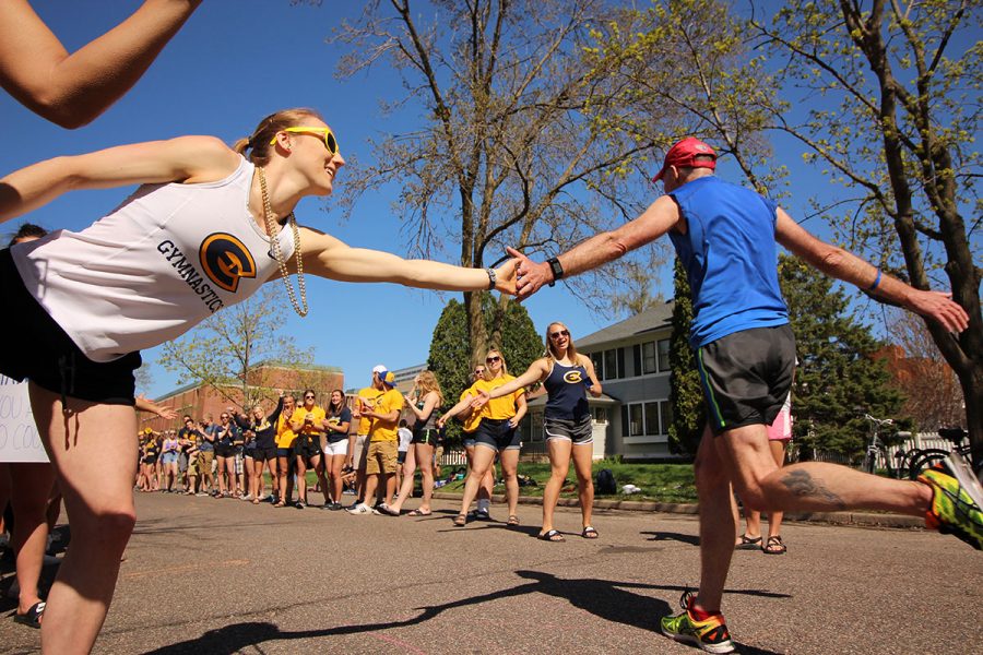 Students cheer on runners in the 2018 Eau Claire Marathon running through the Blugold Mile. 