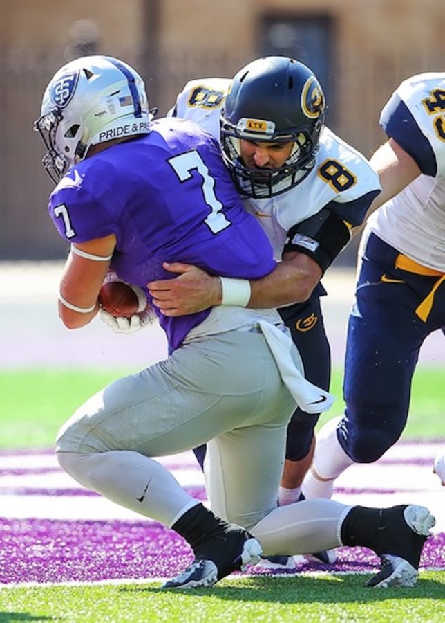 Drew Hurley tackles one of St. Thomas’s players on Saturdays game. The Blugold’s last out-of-conference game of the season ended in a 49-0 loss.