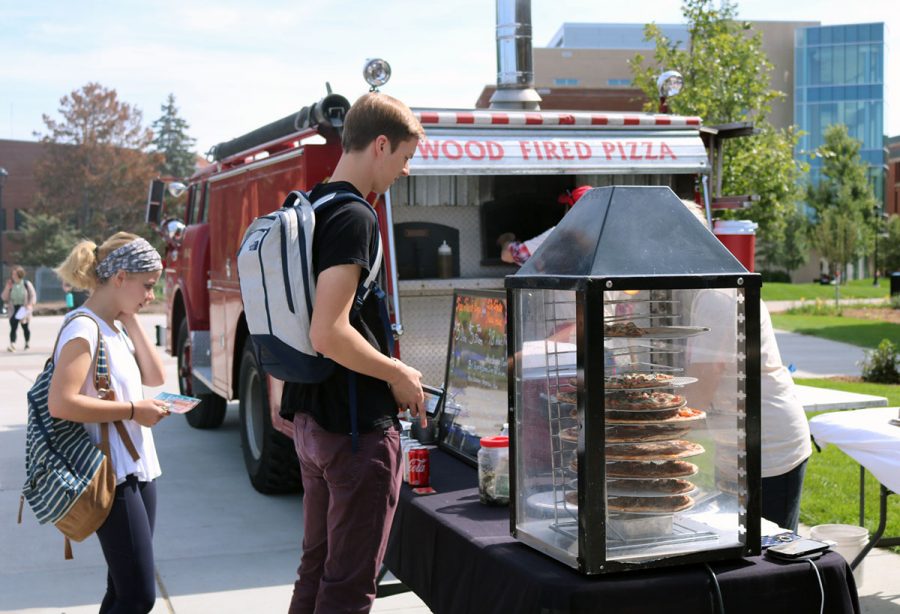 Julia Rindahl and James Selje, sophomore students, take advantage of UW-Eau Claire’s Grab n’ Go food trucks. 
