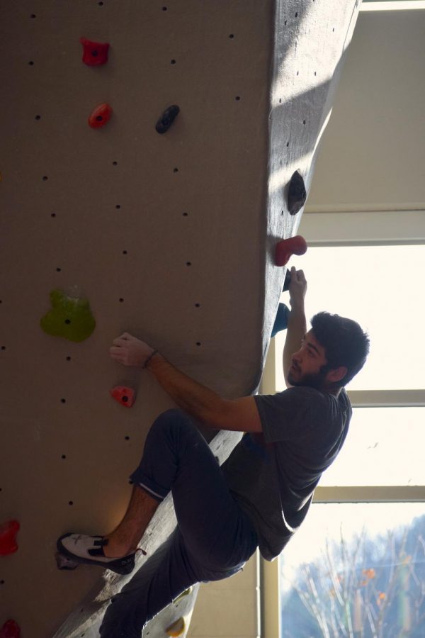 Austin+Perkins+scales+a+wall+during+a+bouldering+competition+at+UW-River+Falls.+Perkins+coaches+Eau+Climbers%2C+the+indoor+climbing+club+at+UW-Eau+Claire.