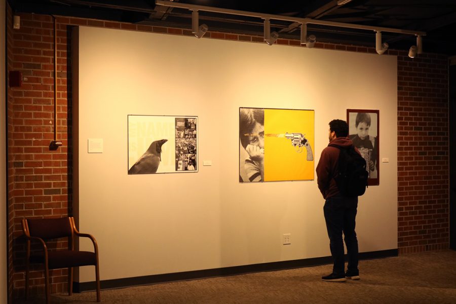 A student examines the graphic portion of the gallery.