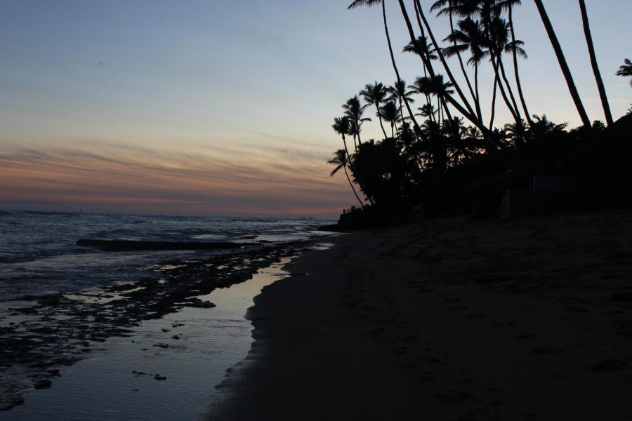 The sun sets and reflects into the ocean at a hidden beach close to campus called Cromwell’s. 