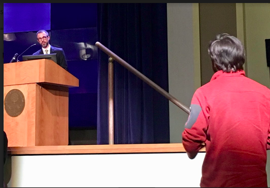 An audience member asks Barry Burden a question after his presentation on gerrymandering. Burden helped co-found the Elections Research Center at UW-Madison. 

