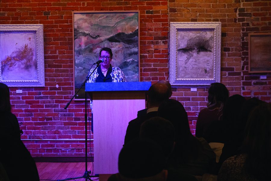 Jessi Peterson reads some of her work at the 6x6 Reading Series event on Tuesday. Readers at the event are only allowed six minutes to read their pieces before the next reader steps up. 