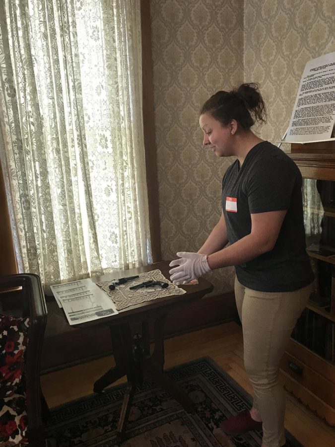 Madeline Jagodzinski, a student in John Mann’s public history course, speaks about the Schlegelmilch guns during the tour inside the historic Schlegelmilch House.
