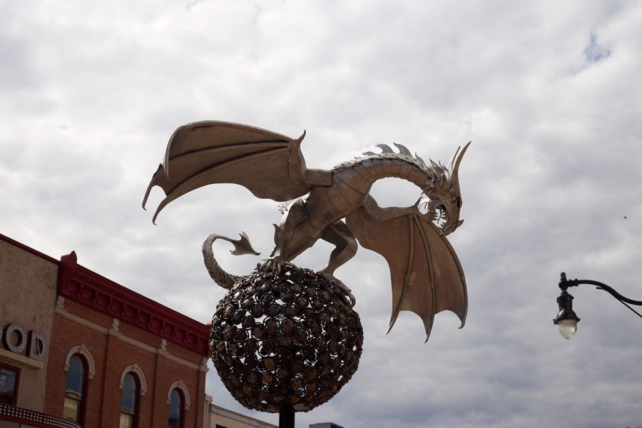 A strong metal dragon gazes over the public. 