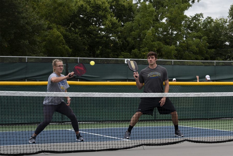 Pickleball teammates prepare to play for Pickapolooza.